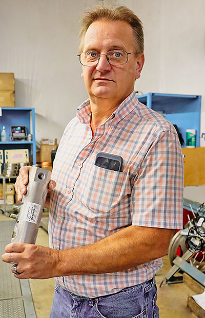 Load Cell Production Supervisor Mac Forest holding a SmartCell SCBD load cell body