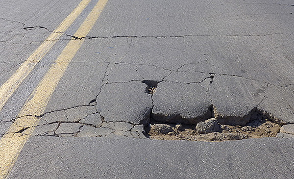 Roadway damage caused by overweight trucks.